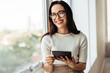 © (JLco) Julia Amaral - Happy female professional holding a tablet in an office
