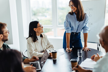 Poster - Mature business woman having a discussion with her team in a meeting