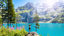 Beautiful blue lake in Swiss and happy woman hiker