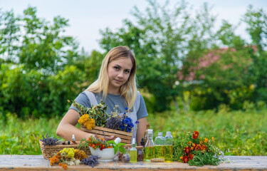 Wall Mural - Woman with medicinal herbs and tinctures. Selective focus.