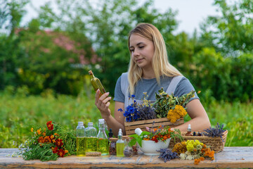 Wall Mural - Woman with medicinal herbs and tinctures. Selective focus.