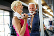 © NDABCREATIVITY - Senior fit man and woman doing exercises in gym to stay healthy