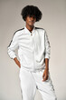 © kiuikson - Portrait of fashionable black man in white tracksuit