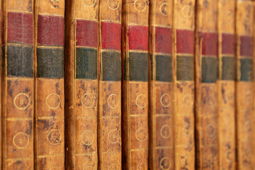 Wall Mural - Pile of antique books with a leather cover and golden ornaments on a wooden table