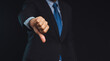 © meeboonstudio - Negative concept. Close-up of businessman's hand showing a thumbs down for dislike service