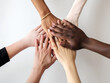 © Marcos - multiethnic hands together, teamwork and unity concept, white background, generative AI