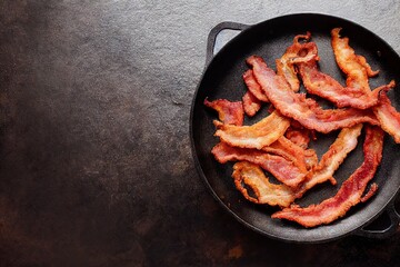 Sticker - Cast iron skillet with pieces of fried bacon for cooking fatty foods, created with generative ai