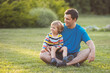 © Evgeniya Grande - Portrait of father and child together on summer day. Copy space.