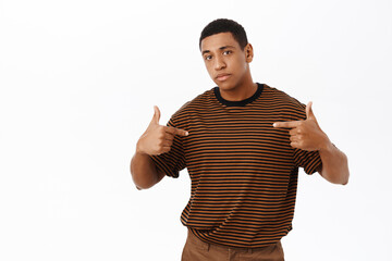 Wall Mural - African american man pointing at himself, standing in casual clothes