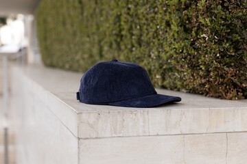 Wall Mural - MOKITUP: Lifestyle Isolated Corduroy Strapback Hat Mockup on Concrete Against Bushes Profile View