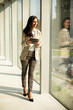© BGStock72 - Young businesswoman walking on modern office hallway
