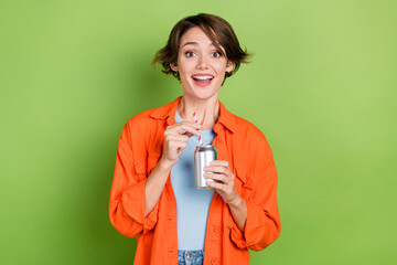 Photo of funky excited lady dressed jeans shirt enjoying cola can isolated green color background