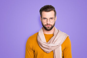 Poster - Portrait of stylish attractive stylist in sweater and gasses with scarf around neck looking at camera isolated on grey background