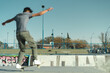© Pajaros Volando - Skatepark with skater boarder doing trick on a beautiful sunny day. Selective focus