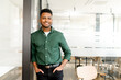 © Vadim Pastuh - Portrait of an elegant stylish indian businessman standing in the modern office and posing against the glass partition with the hands in pockets, looking at the camera, male office employee, manager