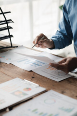 Businessman sits in a private office at his company and is reviewing company financial documents, senior management checking financial information for accuracy. Financial management.