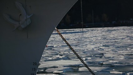 Sticker - Rusty anchor chain attached to boat on frozen sea.The surface of water covered with melting ice