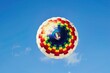 Colorful rainbow parachute in the bright clear sky straight from below