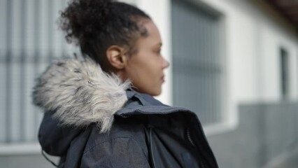 Sticker - African american woman looking to the side with serious expression at street