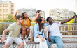 © carlesiturbe - Multiracial group of friends making a selfie with phone in the city- friendship, happiness and joyful concept
