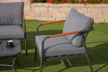 close up,wood sofa and table made of metal and wood in the yard and garden on the grass
