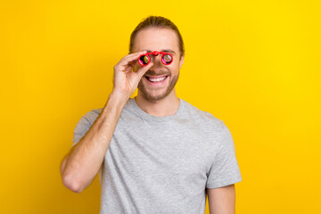 Sticker - Photo of joyful optimistic man wear grey clothes have fun watching observing around isolated on yellow color background