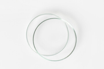 two empty petri dishes on a light background.