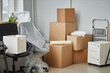 © Seventyfour - Relocation to a new office with packed cardboard boxes and furniture