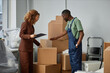 © Seventyfour - Businesswoman showing packed boxes to worker and giving him recmmendations during relocation