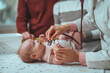 © Dragana Gordic - Doctor pediatrician and baby patient. Medical checkup. Doctor pediatrician examining little baby with stethoscope in clinic.
