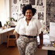© TRINETTE + CHRIS - Portrait of smiling confident curvy Black woman small business owner smiling in her office.
