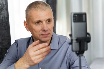 Poster - Businessman, psychologist communicates with internet audience using smartphone, smiles.