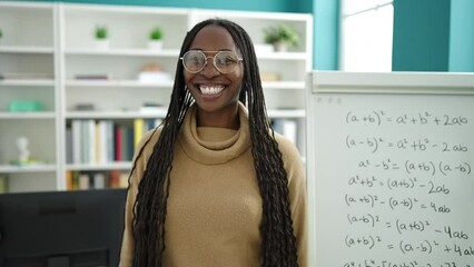 Poster - African woman smiling confident by maths magnetic board at library university