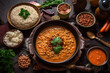 Indian food, top view of cooked and uncooked lentils served with traditional rice and traditional red lentil soup.