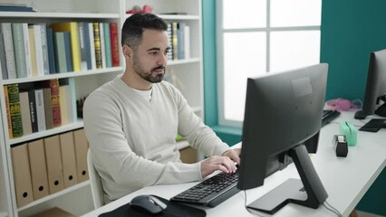 Sticker - Young hispanic man student using computer studying at library university