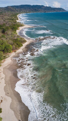 Aerial photography in Costa Rica, beach forest and ocean waves during sunset colors, amazing trip travel