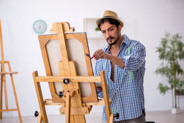 Wall Mural - Young man enjoying painting at the studio