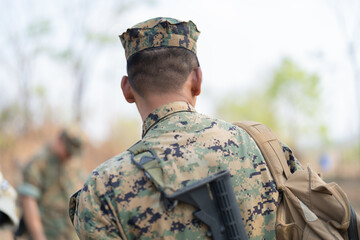 Team of U.S. Army marine corps soldier military war with gun weapon participating and preparing to attack the enemy in Thailand during exercise Cobra Gold training in battle. Combat force.