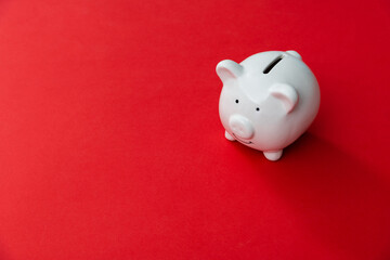 Piggy bank on red background