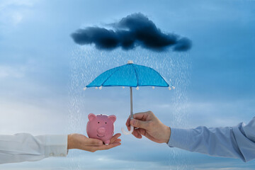 Wall Mural - Toy umbrella covering piggy bank