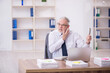 © Elnur - Old male employee and too much work in the office