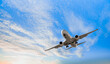 © muratart - White passenger airplane flying in the sky amazing clouds in the background - Travel by air transport