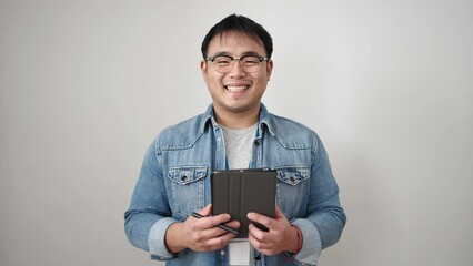 Sticker - Young chinese man smiling confident using touchpad over isolated white background