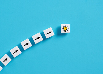 Wall Mural - achieving a creative idea. generating an idea. brainstorming and teamwork. arrow and light bulb symb