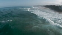 Aerial Dolly Over Salty Ocean Spray Coming Off Top Of Crashing Waves