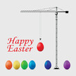Happy easter concept. A tower crane lifts a number of Easter eggs.