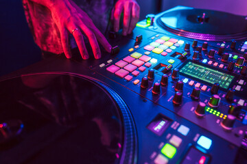 Wall Mural - Close up of DJ hands on dj console mixer during concert in the club