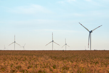 Silhouette of wind turbines at sunset. The concept of alternative energy.