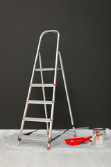 Canvas Print - Metallic folding ladder and painting tools near gray wall indoors