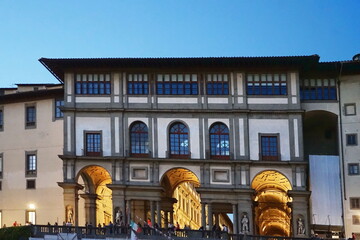 Wall Mural - Uffizi Gallery at the evening seen from a boat on the Arno River in Florence, Tuscany, Italy